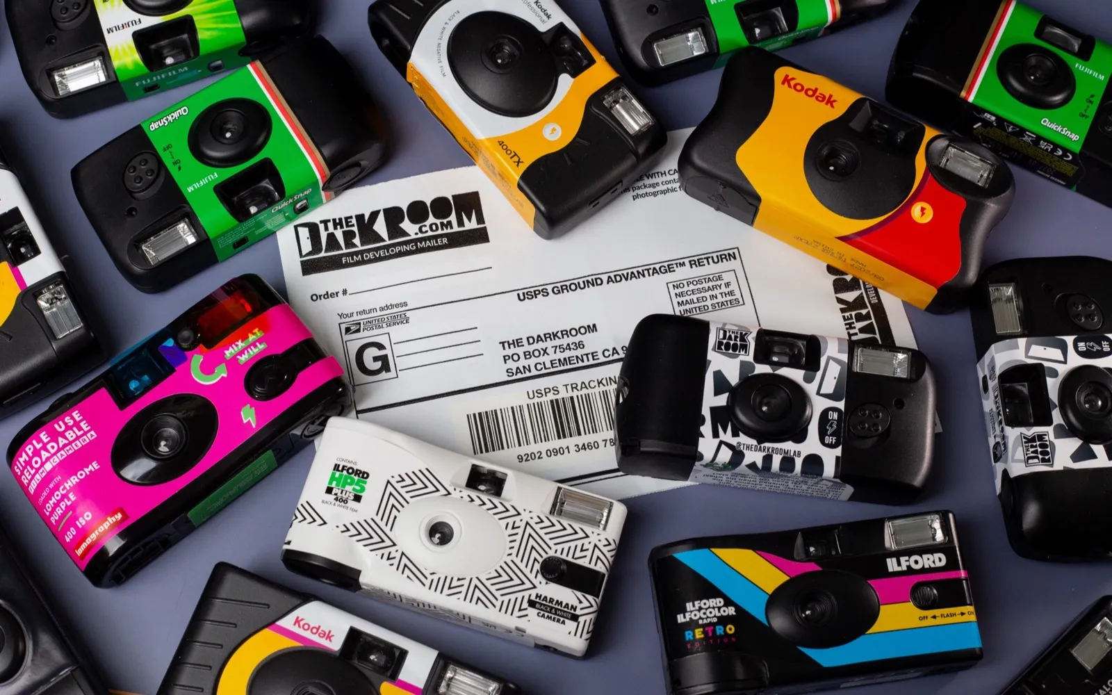 A pile of single-use film cameras of the kind guests hand around at a wedding.